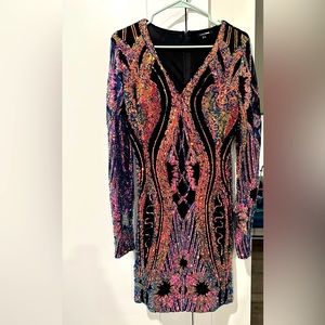 This sequin mini dress is sure to turn heads at a party or any function.